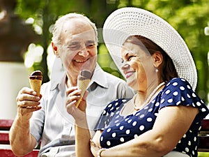 Happy old couple with ice-cream.