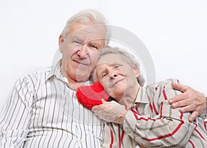 Happy old couple with red heart
