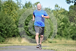 Happy Old Male Senior Running In Park