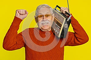 Happy old man listen music on retro tape record player, disco dancing, fan of vintage technologies