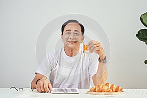 Happy old man positive, Portrait Asian Senior man drinking orange juice from glass