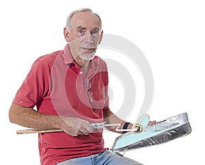 Happy old man preparing to paint with roller