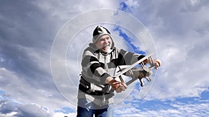 Happy old man pretend flying on wooden airplane sky-high, flight