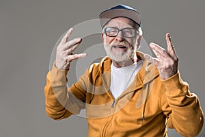 Happy old man waving his hands