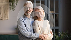 Happy old senior retired family couple bonding posing for portrait