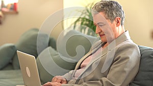 Happy old senior woman grandmother using laptop computer at home. Beautiful happy business woman with short haircut