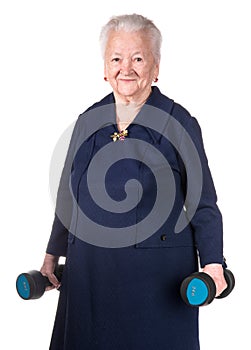 Happy old woman making fitness training with dumbbells