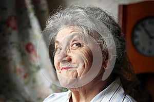 Happy old woman portrait on a dark background