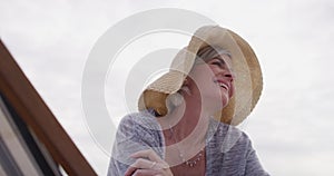 Happy, old woman and relax on holiday with chair at the beach and thinking of retirement with freedom. Summer, vacation