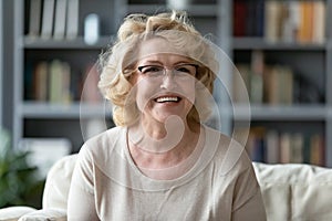 Happy older 60s woman enjoying video call conversation.