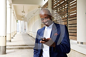Happy older african businessman with cell phone
