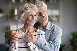 Happy older couple hugging, dreaming about good future together