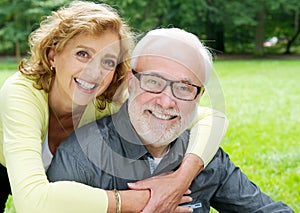 Happy older couple smiling and showing affection