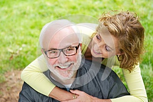 Happy older man with beautiful woman smiling outdoors