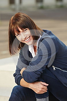 Happy older woman with cheerful expression outside