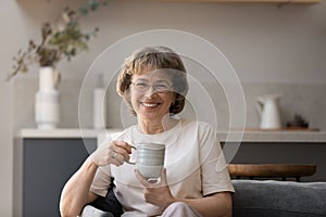 Happy older woman in glasses enjoying good morning