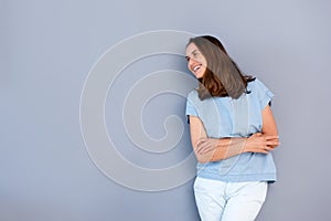 Happy older woman smiling against gray background