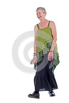 Happy older woman stands in flowing long dress