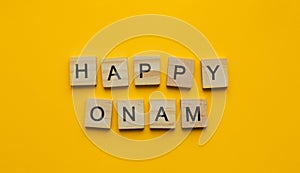 Happy Onam Festival, minimalistic banner with the inscription in wooden letters