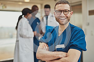 Happy optimistic young hospital surgeon