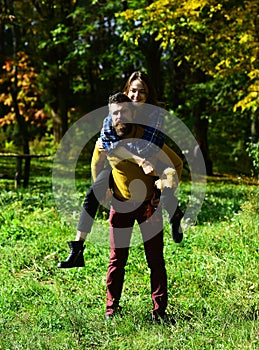 Happy ouple in autumn park. Young family has fun outdoors