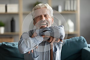 Happy overjoyed retired disabled mature grandfather looking at camera.