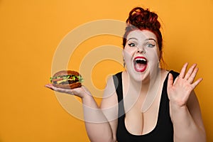 Happy overweight fat woman happy hold big burger cheeseburger sandwich. Girl on diet dieting. Healthy eating  fast food concept