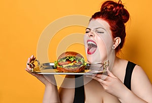 Happy overweight fat woman happy hold burger cheeseburger sandwich with beef. Healthy eating dieting fast food concept