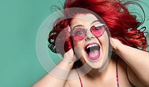 Happy overweight fat woman happy screaming and closing her ears with hands having good time crazy shopping sale