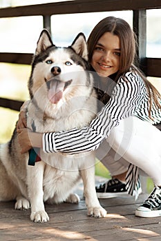 Happy owner and dog. Love for animals. A smiling husky