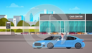 Happy Owner Driving New Car Over Dealership Center Showroom Building Background