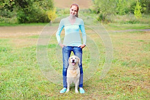 Happy owner woman with Golden Retriever dog walking together