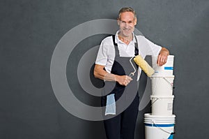 Happy painter holding roller