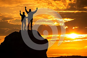 Happy pair silhouettes over sea and mountains