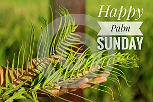 Happy Palm Sunday text desig on fresh green bakcgorund and fern or palm leaf concept.