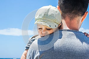 Happy parent with a child by the sea in the open air