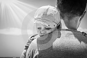 Happy parent with a child by the sea in the open air