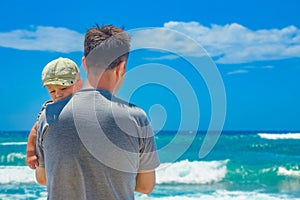 Happy parent with a child by the sea in the open air