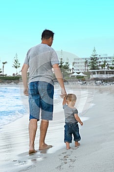 happy parent with a child by the sea in the open air