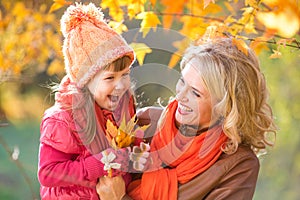 Happy parent and kid holding autumn yellow