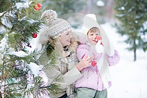 Happy parent and kid playing with christmas tree