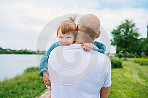 Happy parent playing with child outdoors in park