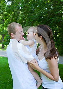 Happy parents with baby boy outdoors