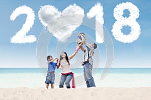 Happy parents with children and numbers 2018