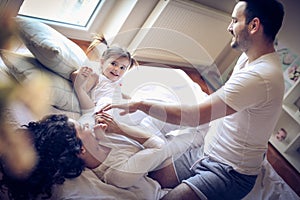 Happy parents have play with their little girl.