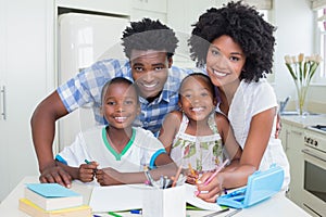 Happy parents helping children with homework