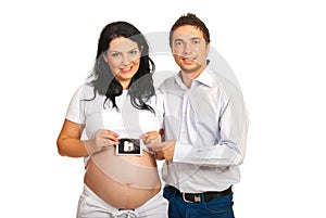 Happy parents holding baby sonogram