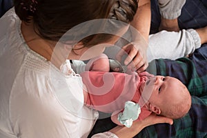 Happy parents holding their newborn baby girl