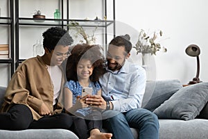 Happy parents and kid using online learning app on cellphone