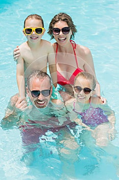 Happy parents and kids in pool